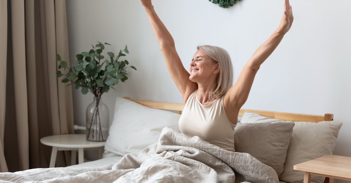 Waking up refreshed Middle aged woman with grey hair waking up happy and refreshed