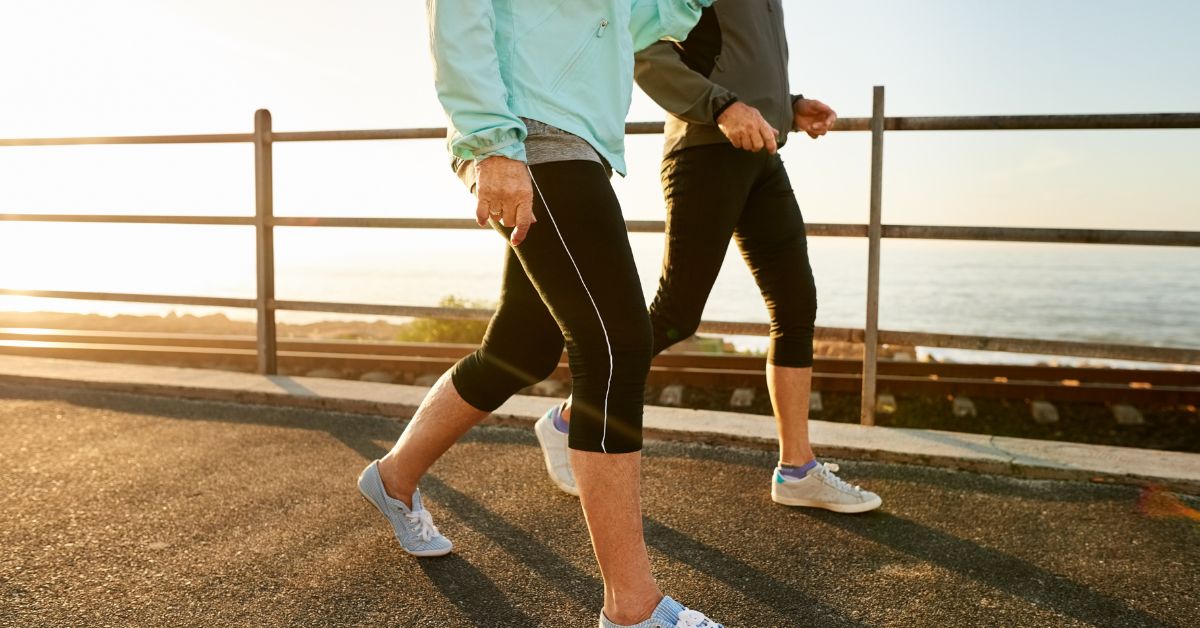 improve-resting-heart-rate-walking-exercise-stressfreelongevity Two people brisk walking outdoors — aerobic exercise is the most effective way to lower resting heart rate