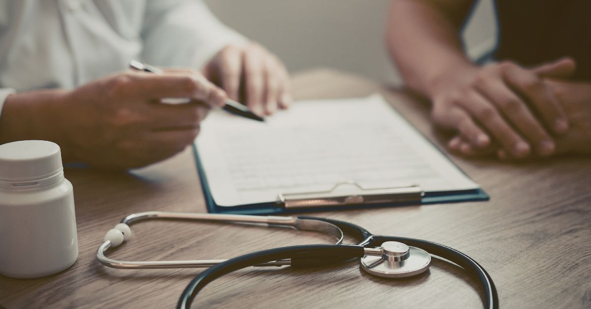 resting-heart-rate-when-to-see-doctor-stressfreelongevity Doctor discussing results with patient — when to talk to your doctor about resting heart rate