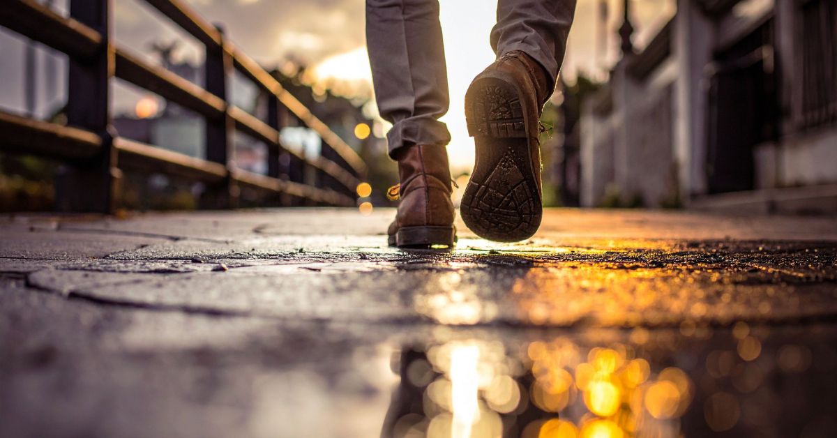 best-exercise-to-live-longer-walking-stressfreelongevity Person walking outdoors at sunset — the most accessible exercise for longevity