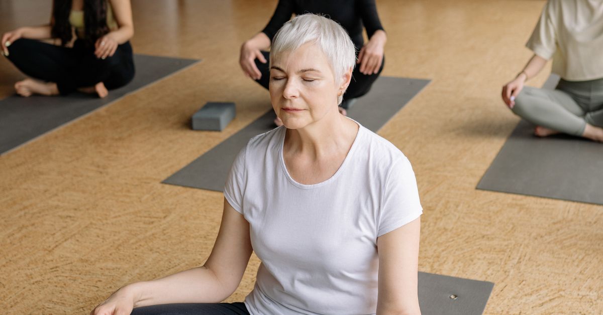 Woman practising slow breathing in a class — the strongest evidence-based way to improve HRV