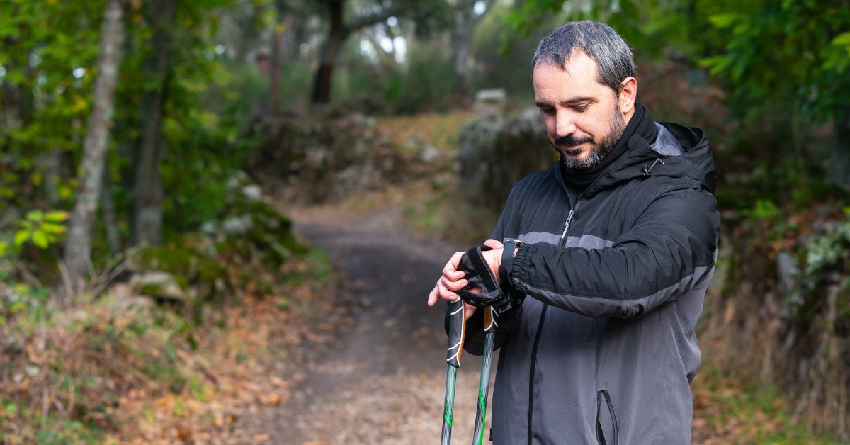 vo2-max-by-age-stressfreelongevity Man checking smartwatch on forest trail — VO2 max by age