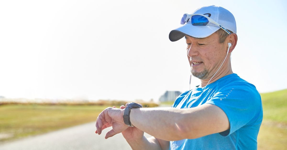 Man checking his fitness watch after a run outdoors