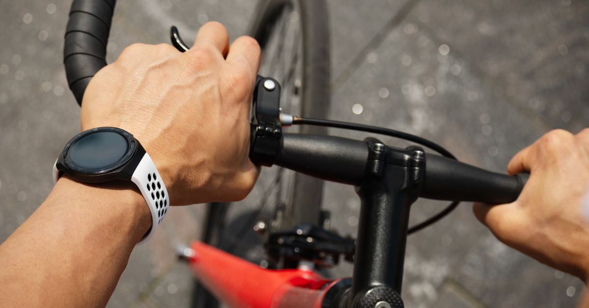 Cyclist wearing smartwatch while cycling outdoors