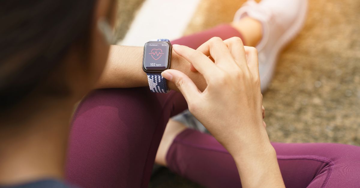 Person checking heart rate on smartwatch after exercise