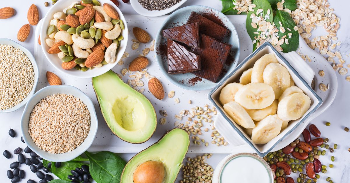 Magnesium-rich foods including pumpkin seeds, almonds, spinach, dark chocolate and avocado