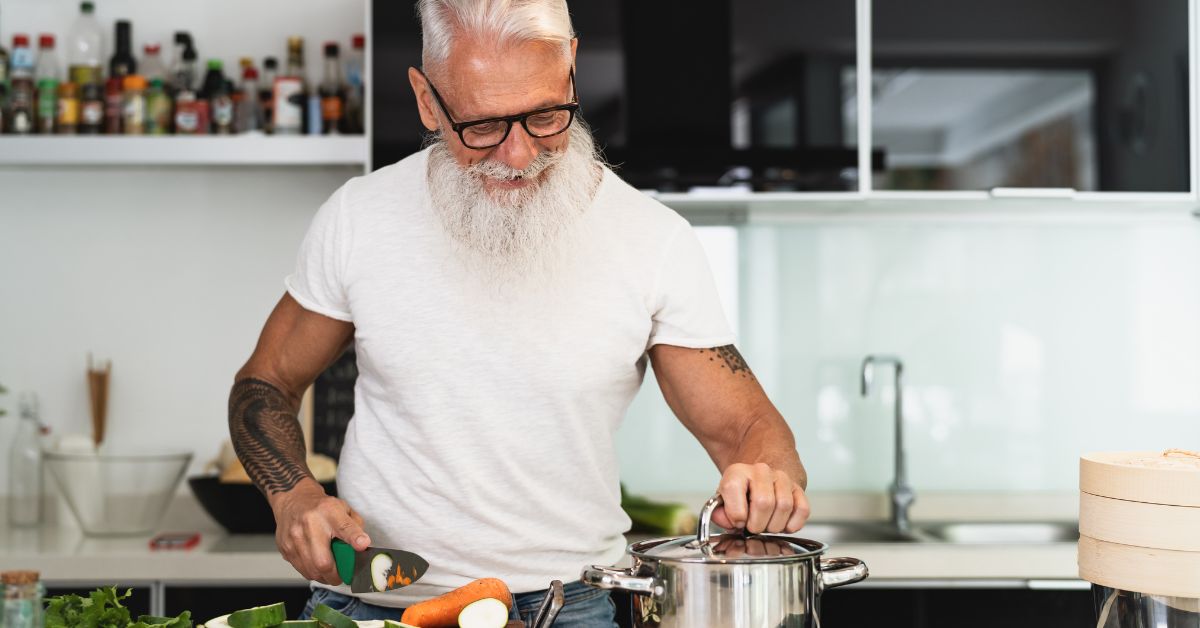 walking-listening-music-zone-2-stressfreelongevity. (33) Man in his 50s cooking a fresh meal at home — losing weight through diet can increase testosterone