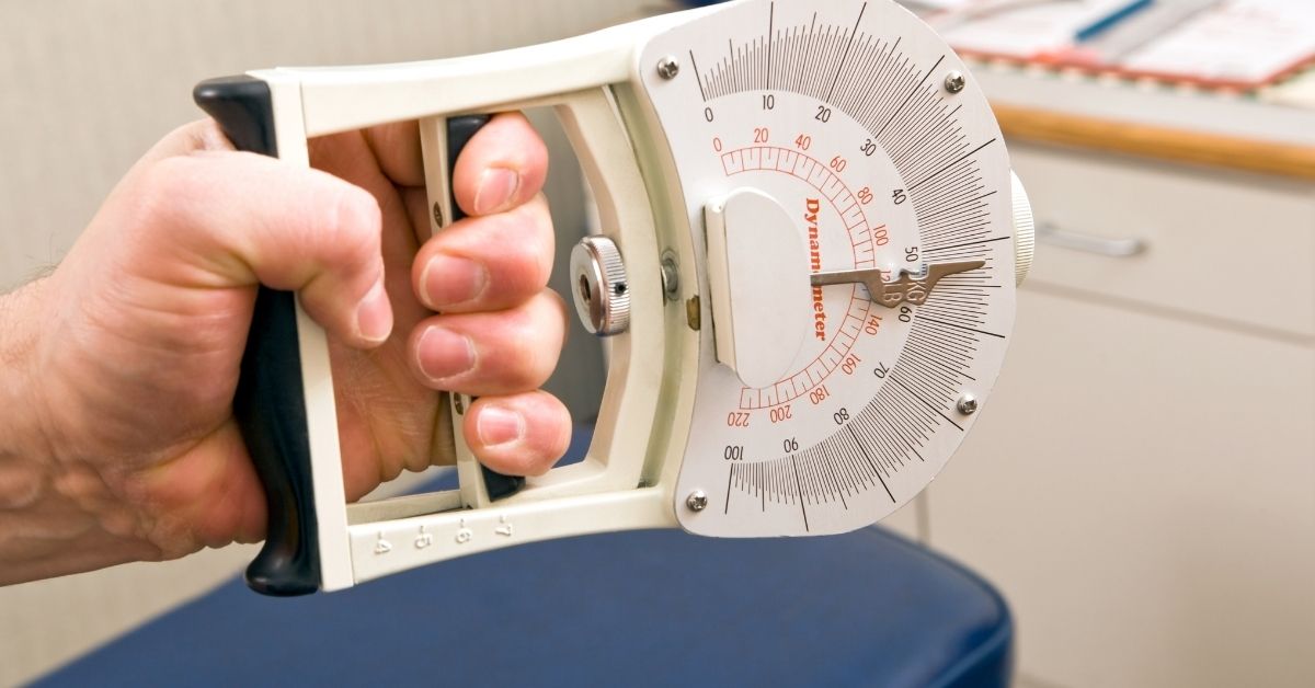 grip-strength-chart-dynamometer-reading-stressfreelongevity Hand squeezing a grip strength dynamometer showing a reading in kilograms and pounds